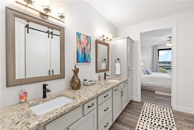 1065 Topsider Ln Unit 408, Osage Beach, MO 65065 - ensuite bathroom with double vanity, wood finished floors, baseboards, and a ceiling fan