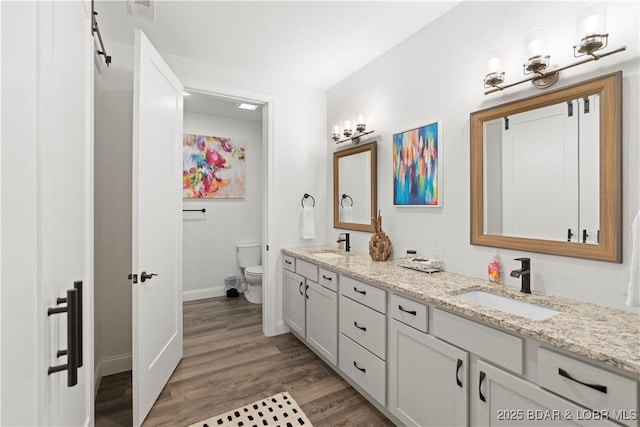 1065 Topsider Ln Unit 408, Osage Beach, MO 65065 - full bathroom with double vanity, toilet, wood finished floors, and baseboards
