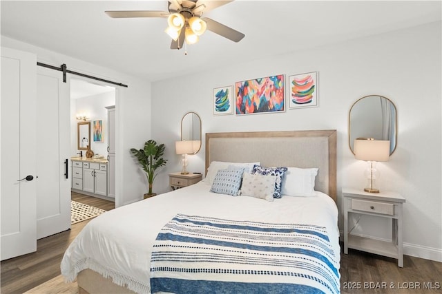 1065 Topsider Ln Unit 408, Osage Beach, MO 65065 - bedroom with a barn door, wood finished floors, connected bathroom, baseboards, and a ceiling fan