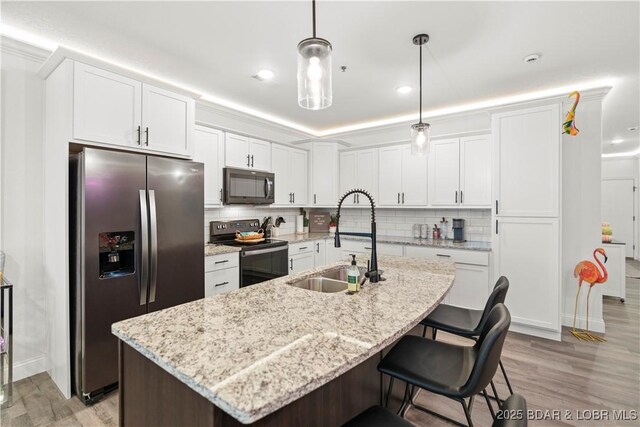 1065 Topsider Ln Unit 408, Osage Beach, MO 65065 - kitchen featuring black appliances, a sink, light wood-style flooring, white cabinetry, and recessed lighting