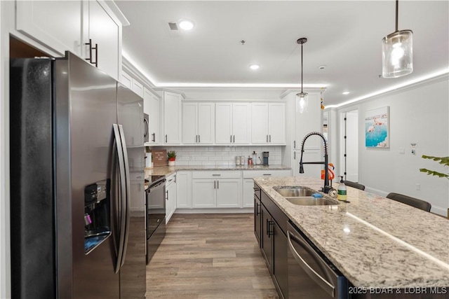 1065 Topsider Ln Unit 408, Osage Beach, MO 65065 - kitchen with stainless steel appliances, a sink, white cabinetry, a kitchen island with sink, and decorative backsplash