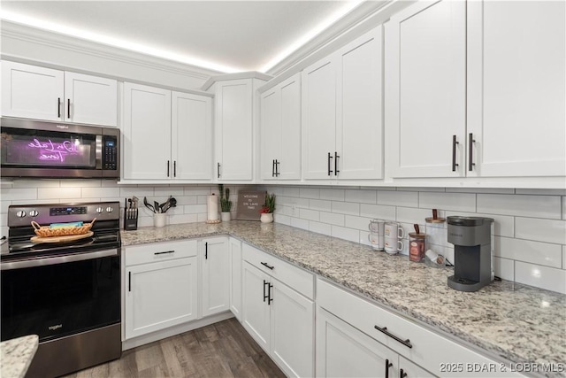 1065 Topsider Ln Unit 408, Osage Beach, MO 65065 - kitchen with stainless steel appliances, white cabinets, decorative backsplash, and wood finished floors