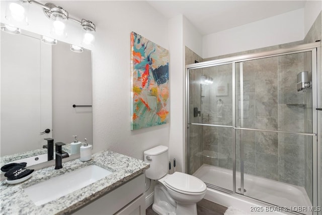 1065 Topsider Ln Unit 408, Osage Beach, MO 65065 - bathroom with vanity, a stall shower, and toilet