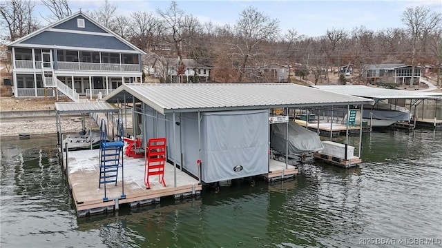 dock area with a water view and boat lift