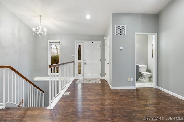 entrance foyer featuring recessed lighting, a notable chandelier, wood finished floors, visible vents, and baseboards