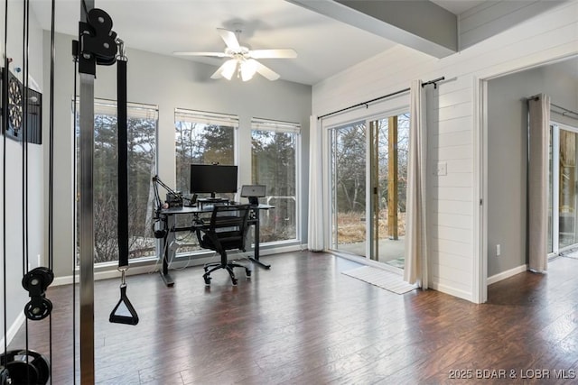 home office featuring baseboards, beam ceiling, a ceiling fan, and wood finished floors