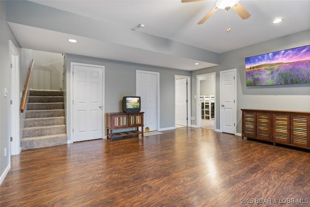 living room with recessed lighting, wood finished floors, baseboards, and stairs