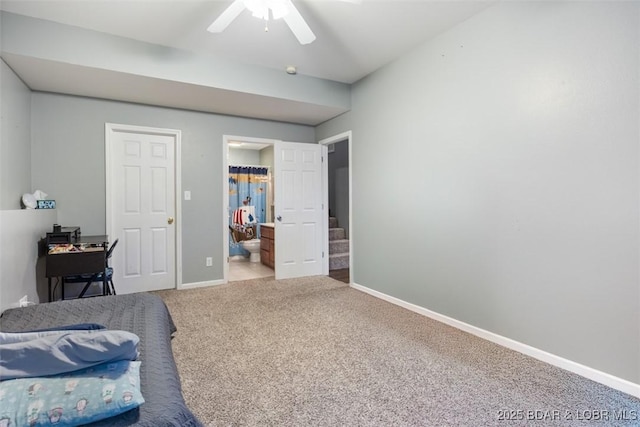 carpeted bedroom with baseboards and connected bathroom