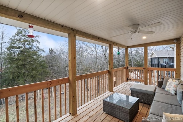 deck featuring outdoor lounge area and a ceiling fan