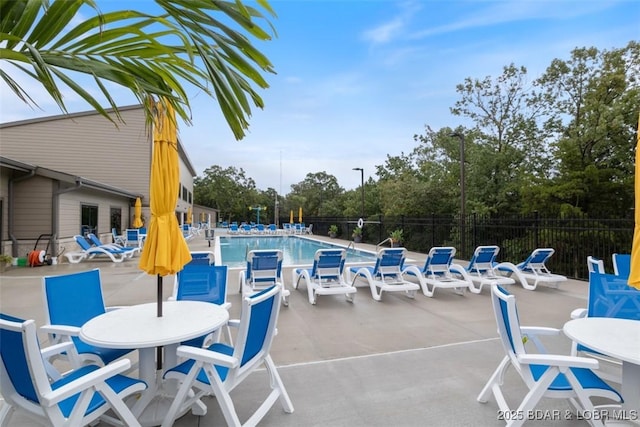 community pool featuring fence and a patio