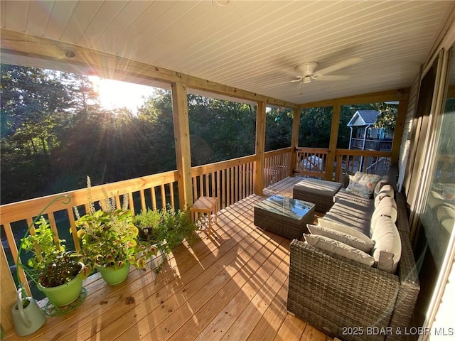 deck featuring an outdoor living space and a ceiling fan