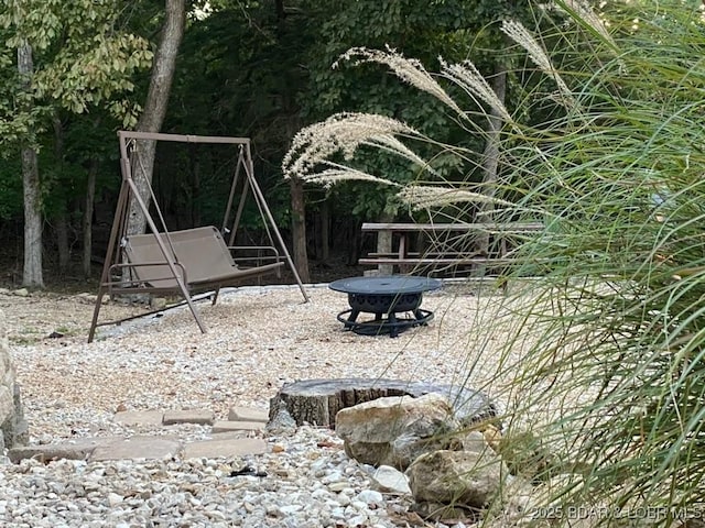 exterior space featuring an outdoor fire pit and a playground