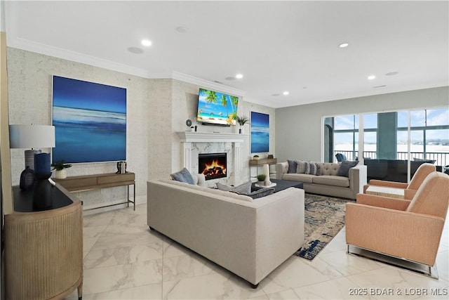 living area with recessed lighting, marble finish floor, crown molding, and a premium fireplace