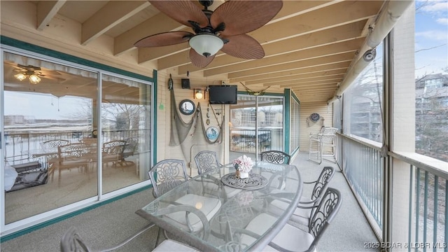 sunroom featuring ceiling fan