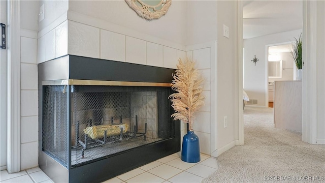 interior details featuring a fireplace and carpet flooring