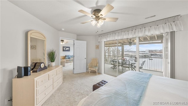 bedroom featuring a ceiling fan, access to outside, light carpet, and visible vents