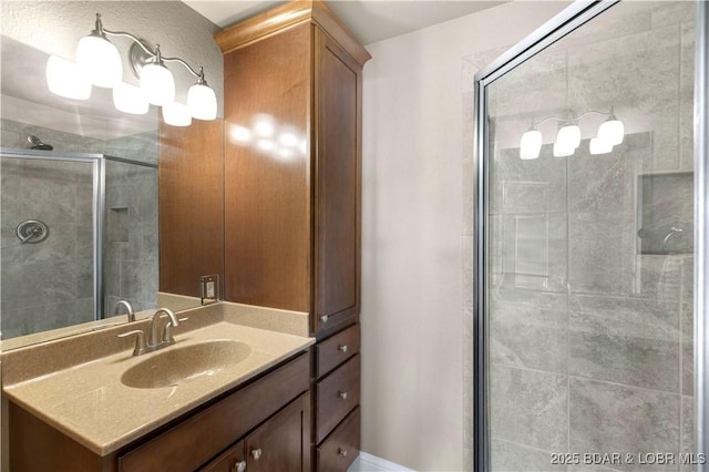 bathroom with a stall shower and vanity