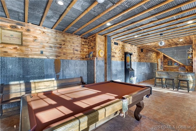 playroom featuring a dry bar, wood walls, concrete flooring, and pool table