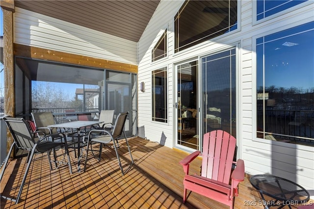 wooden deck featuring outdoor dining area