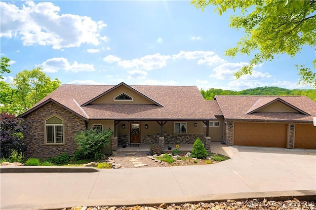 175 Black Rock Rd, Camdenton, MO 65020 - view of front of property featuring a garage, stone siding, a shingled roof, driveway, and a porch