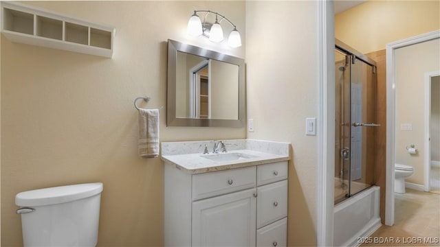 bathroom featuring shower / bath combination with glass door, vanity, and toilet