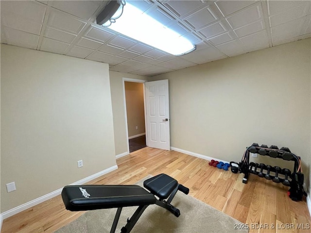 exercise area featuring wood finished floors and baseboards