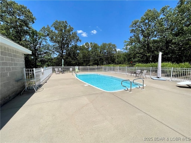 community pool featuring fence and a patio