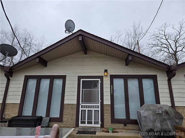 back of property with stone siding