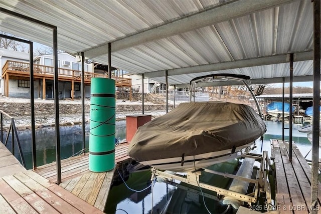 dock area with a water view and boat lift