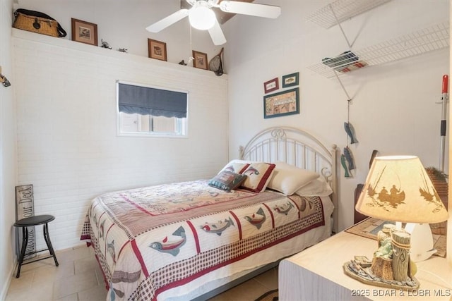 tiled bedroom featuring a ceiling fan