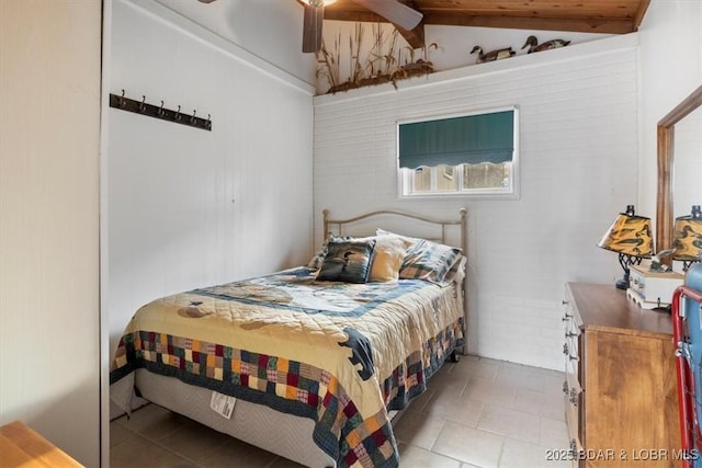 bedroom featuring lofted ceiling, a ceiling fan, and light tile patterned flooring