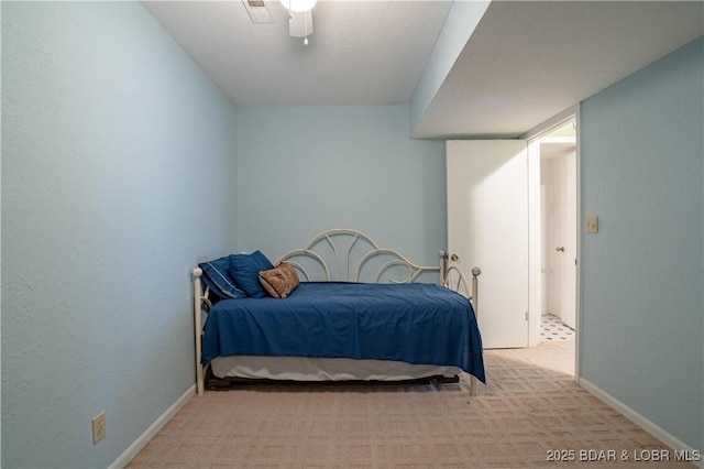 bedroom featuring a ceiling fan, light carpet, visible vents, and baseboards