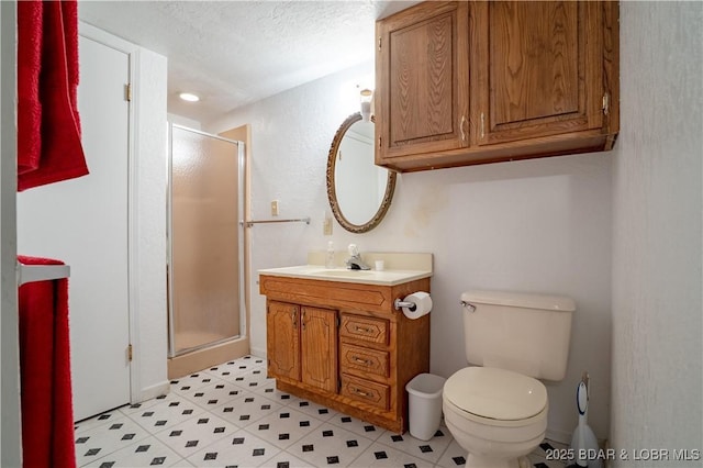 full bathroom with toilet, a shower stall, vanity, and a textured ceiling