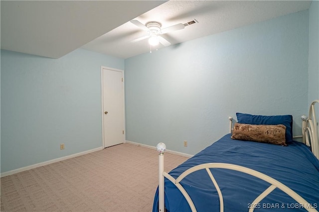 unfurnished bedroom with carpet floors, visible vents, baseboards, and ceiling fan