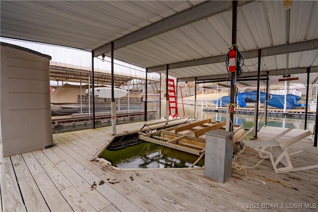 dock area with a water view and boat lift