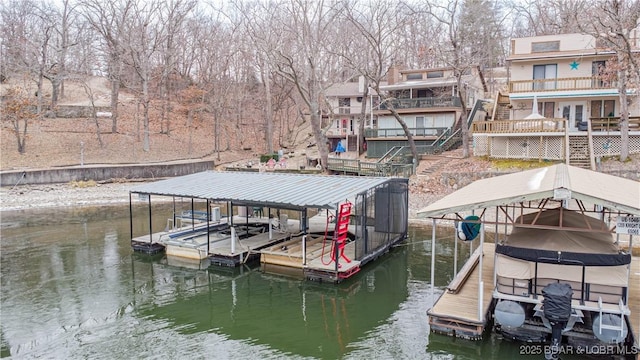 view of dock featuring stairs, a water view, and boat lift