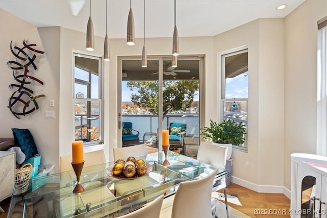 dining space with light wood-style flooring and baseboards