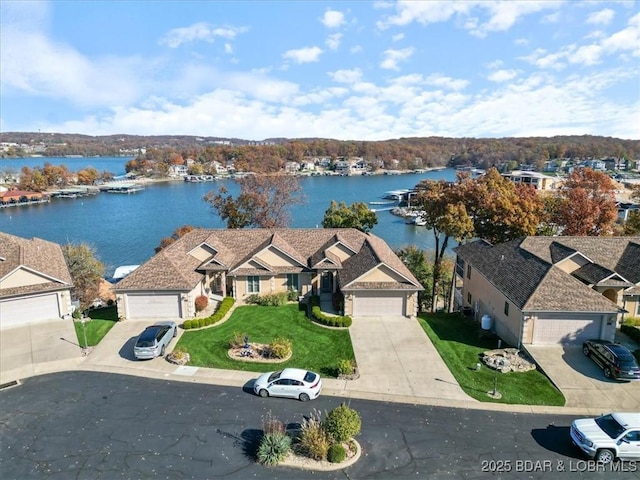 bird's eye view with a water view and a residential view