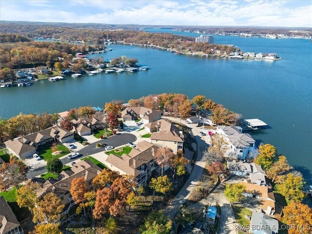 birds eye view of property with a water view and a residential view