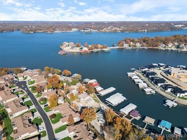 birds eye view of property with a water view and a residential view