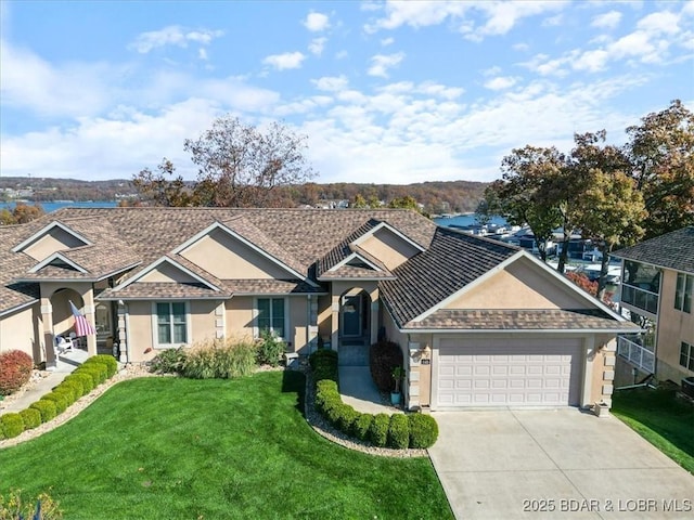 view of front of property featuring a garage, driveway, a front lawn, and stucco siding