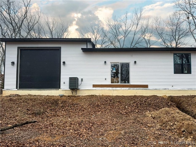 rear view of property with central AC unit