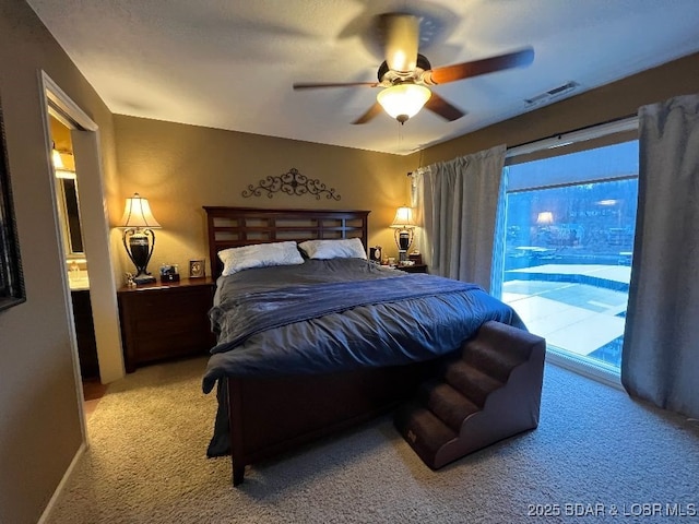 bedroom featuring access to exterior, visible vents, a ceiling fan, and light colored carpet