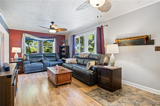 living area featuring a textured ceiling, light wood-style flooring, and a ceiling fan