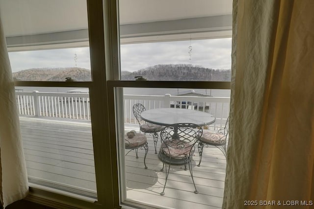 snow covered back of property featuring a mountain view