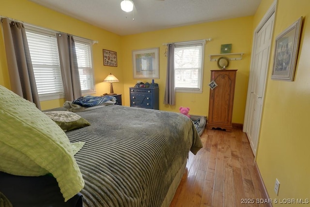 bedroom featuring baseboards and light wood finished floors