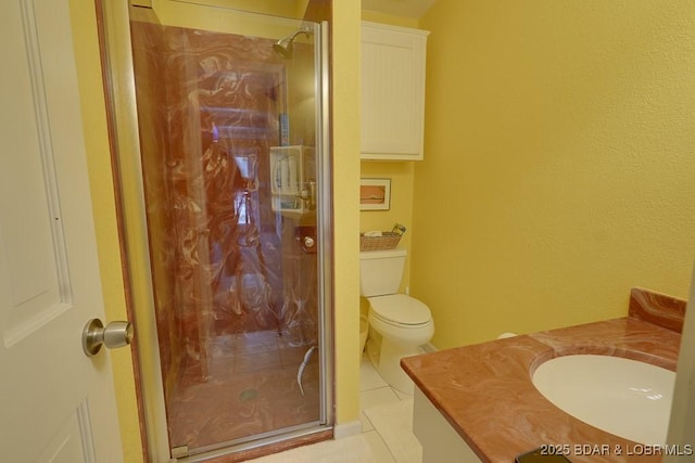 bathroom featuring toilet, vanity, and tile patterned floors