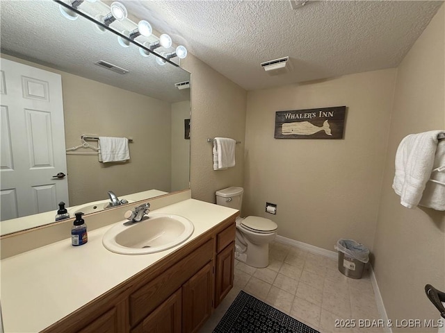 half bath with baseboards, visible vents, toilet, a textured ceiling, and vanity