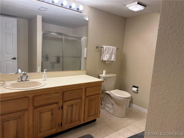 full bath with a textured wall, toilet, a textured ceiling, vanity, and a shower stall