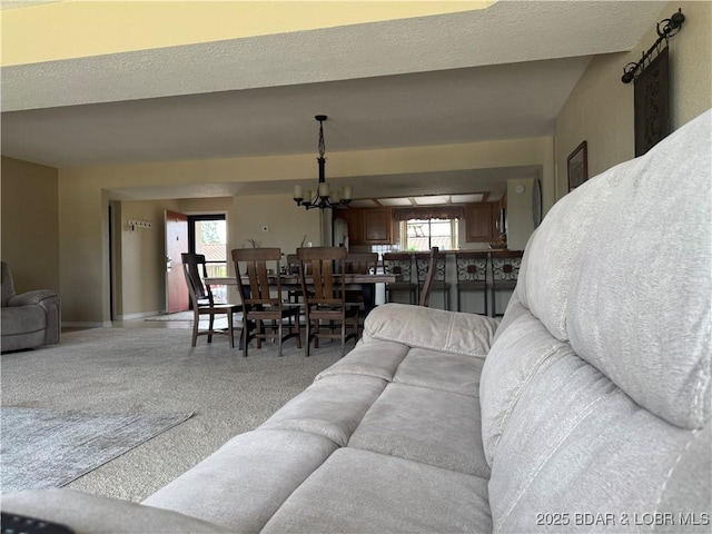 85 La Jolla Dr Unit 352-2A, Lake Ozark, MO 65049 - carpeted living room with a chandelier and baseboards